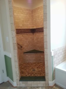 A wider view of shower details shows a built in bench. This is another accessibility accommodation that can benefit anyone. Often the same details once considered matters of ADA compliance make it easier to accommodate young children, thus the frequently heard term universal design.