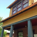 Sherwin-Williams paint on the siding and red porch ceiling, gray trim paint by Farrow & Ball. Restored center columns that had been knocked out by a previous owner. Copper gutters. Farrow & Ball is locally available at Patrick Street Interiors.