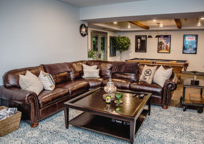 Den space with brown leather couches