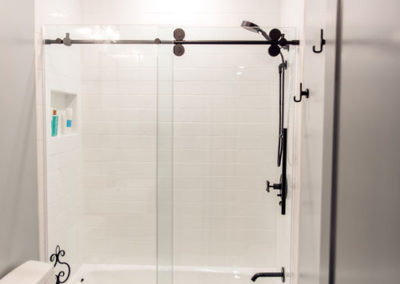 White tile and black fixtures in a shower